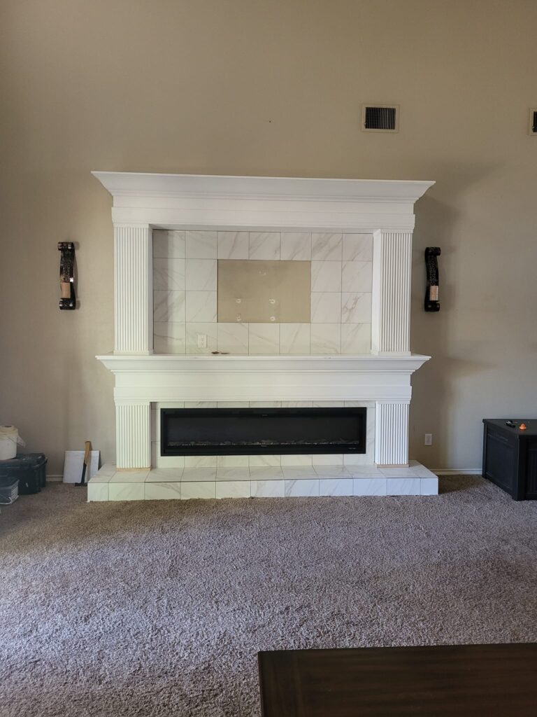 new fireplace and TV mount with custom wood mantel